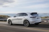 Driving 2019 Porsche Cayenne Turbo AWD in White from a rear left three-quarter view